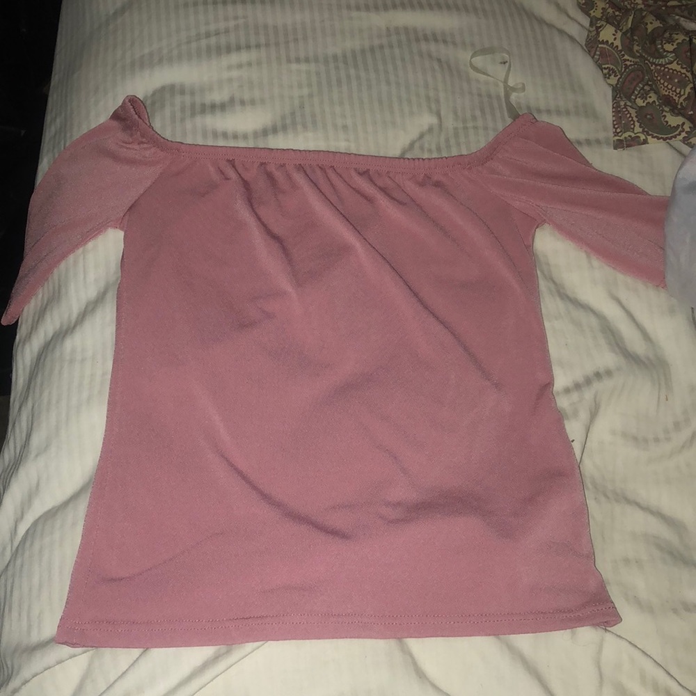 A pink/ Salmon off shoulders shirt.
